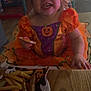 toddler, child, costume, halloween, pumpkin, orange, purple, food, snack, fries, sausages, nuggets, table, plate, napkin, celebration, indoor, happy, smile, party