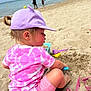 toddler, child, beach, sand, sand_toys, bucket, shovel, ocean, water, sky, hat, pink_shorts, tie_dye_shirt, play, summer, vacation, outdoor, sea, sandcastle, fun