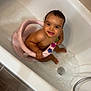 baby, bath_seat, bathroom, bathtub, child, clean, cute, floor_mat, happy, indoor, playful, reflection, safety_seat, sitting, skin, smile, tile_floor, toy, water, young_child