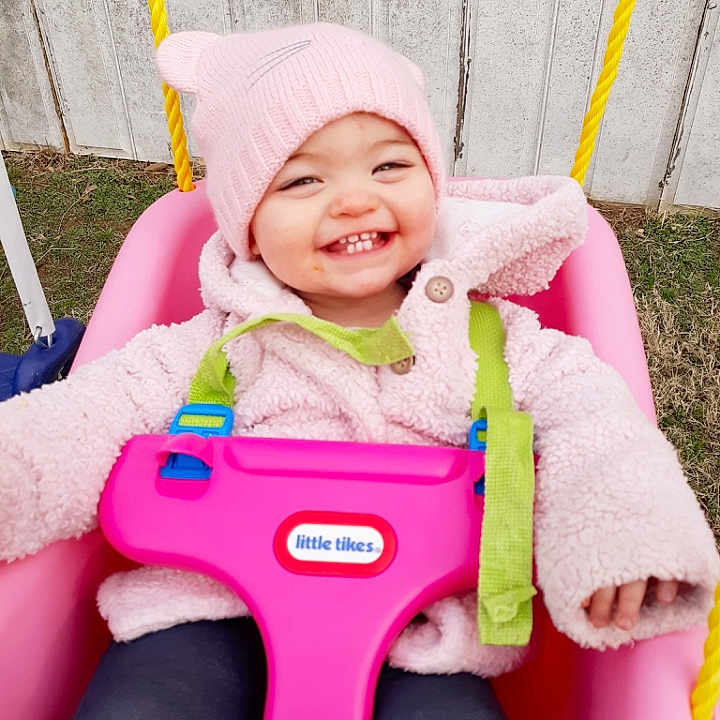 Bethanie joined the competition — help win amazing prizes! baby, child, fun, happy, headwear, joy, outdoor_play_equipment, person, pink, play, product, riding_toy, smile, swing, toddler, vehicle