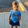 toddler, child, sidewalk, toy, wooden_toy, blue_tshirt, shorts, sneakers, outdoor, curious, sunlight, concrete, casual_clothing, young_child, standing, playtime, daylight, expression, park, summer