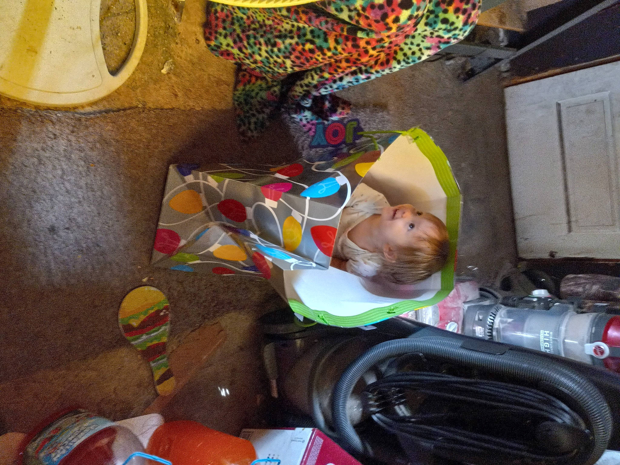 Percilla is registered to the contest to win money with this photo: art, baby, baby_products, box, child, fun, hat, helmet, person, personal_protective_equipment, plastic, room, sitting, toddler, trunk