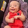 Kashden is registered to the contest to win money with this photo: baby, bracelet, car_seat, child, comfort, cute, face, hands, happy, head, indoor, infant, joy, legs, person, portrait, purple_blanket, red_clothing, skin, smiling