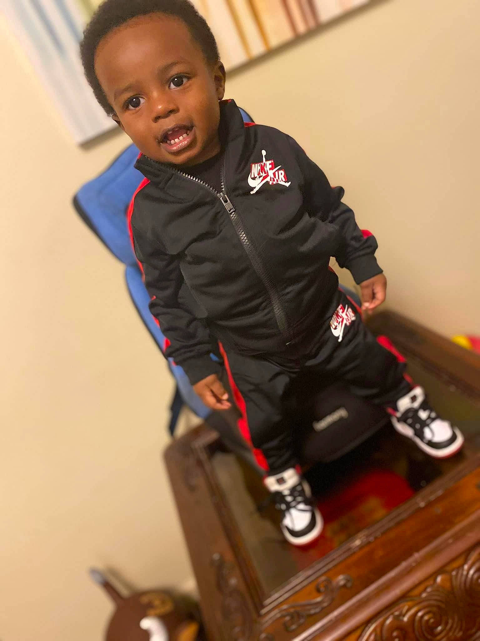 Kayce joined the competition — help win amazing prizes! audio_equipment, child, elbow, electric_blue, gadget, human_body, jacket, joint, knee, leg, person, personal_protective_equipment, sitting, sleeve, sneakers, sportswear, t_shirt, toddler, toy, uniform