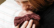 Paisley joined the competition — help win amazing prizes! affection, baby, blanket, bow, closeup, cuddle, family, hair, hand, head, holding, intimate, kiss, love, newborn, parent, portrait, skin, striped, tender