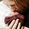 newborn, baby, parent, kiss, bow, head, hand, blanket, striped, closeup, tender, love, affection, family, portrait, skin, hair, holding, cuddle, intimate