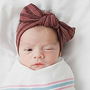 Paisley is registered to the contest to win money with this photo: newborn, baby, infant, wrapped, blanket, headband, bow, winking, face, portrait, cute, sleepy, soft, white, pastel, closeup, child, adorable, young, person