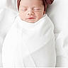newborn, baby, sleeping, swaddled, blanket, headband, white_background, peaceful, infant, portrait, soft_light, cute, wrapped, child, resting, peace, closeup, indoors, fresh, adorable