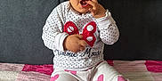 Milena joined the competition — help win amazing prizes! blanket, child, clothing, cute, expression, face, hand, hearts, indoor, minnie_mouse, pants, person, pink, polka_dot, sitting, sofa, sweater, toddler, white, young_child