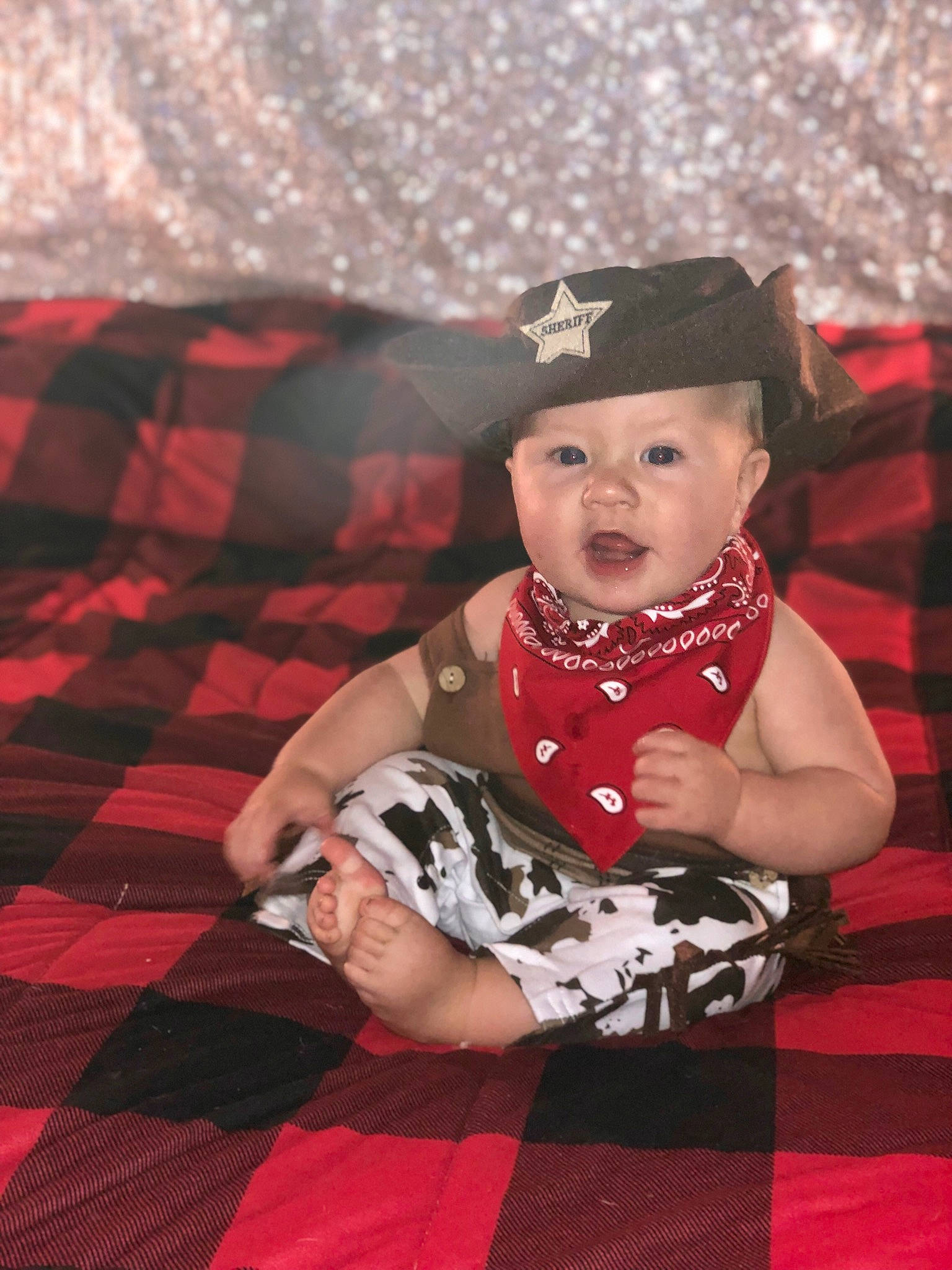 Leland is registered to the contest to win money with this photo: baby, baby_products, baby_toddler_clothing, costume_hat, dress, event, flooring, fun, happy, hat, headwear, linens, magenta, pattern, person, pink, plaid, recreation, sleeve, sun_hat
