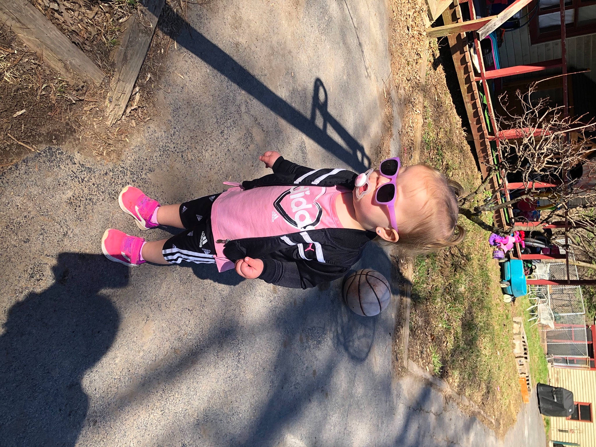 Jacqueline is registered to the contest to win money with this photo: asphalt, baby_products, carmine, child, city, fun, helmet, leisure, person, personal_protective_equipment, plant, recreation, shadow, sidewalk, toddler, tree, walking_shoe