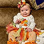 baby, child, smile, couch, tutu, headband, bow, striped_leggings, orange, white, fall, autumn, cute, happy, toddler, sitting, blanket, plush, person, indoor
