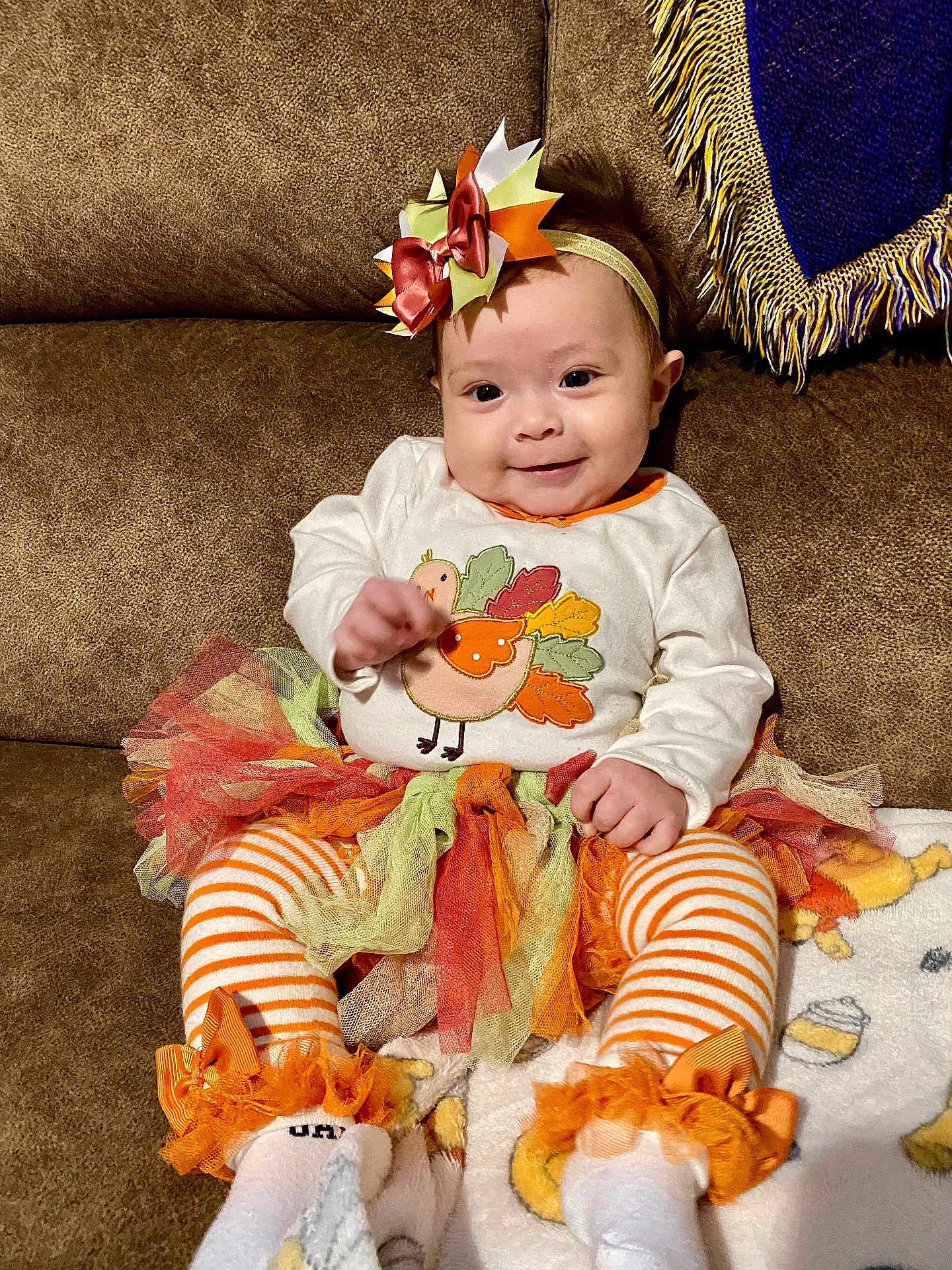 Lyra joined the competition — help win amazing prizes! baby, child, smile, couch, tutu, headband, bow, striped_leggings, orange, white, fall, autumn, cute, happy, toddler, sitting, blanket, plush, person, indoor