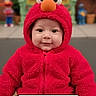 baby, child, costume, elmo, red_clothing, cute, smile, portrait, infant, hooded_jacket, face, eyes, indoor, colorful, background, plush, young_child, sitting, happy, closeup