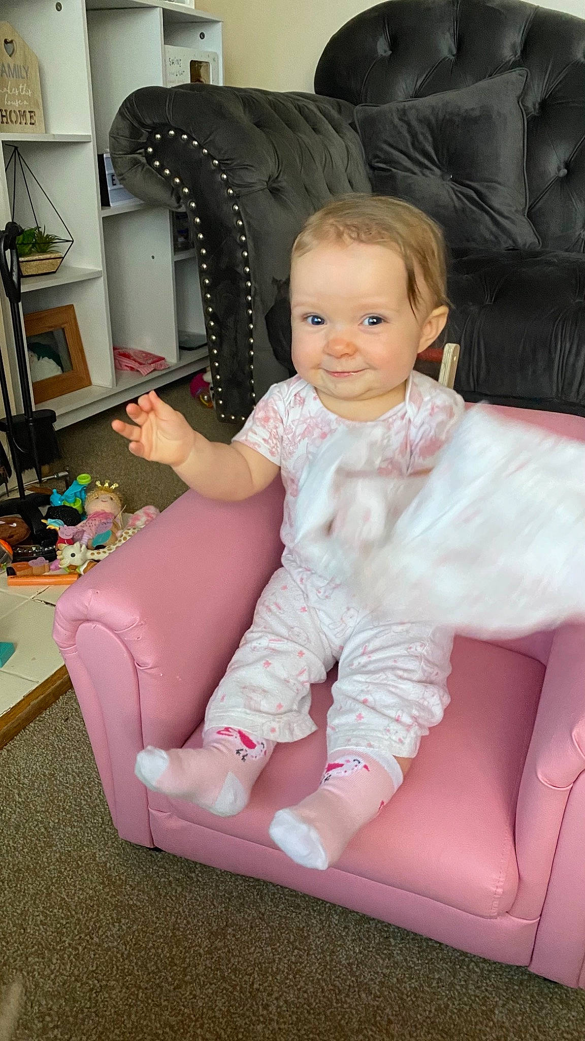 Macy joined the competition — help win amazing prizes! baby, baby_toddler_clothing, blond, bookcase, chair, clothing, comfort, furniture, happy, human_body, iris, joy, knee, lap, magenta, person, pink, shelf, sleeve, smile