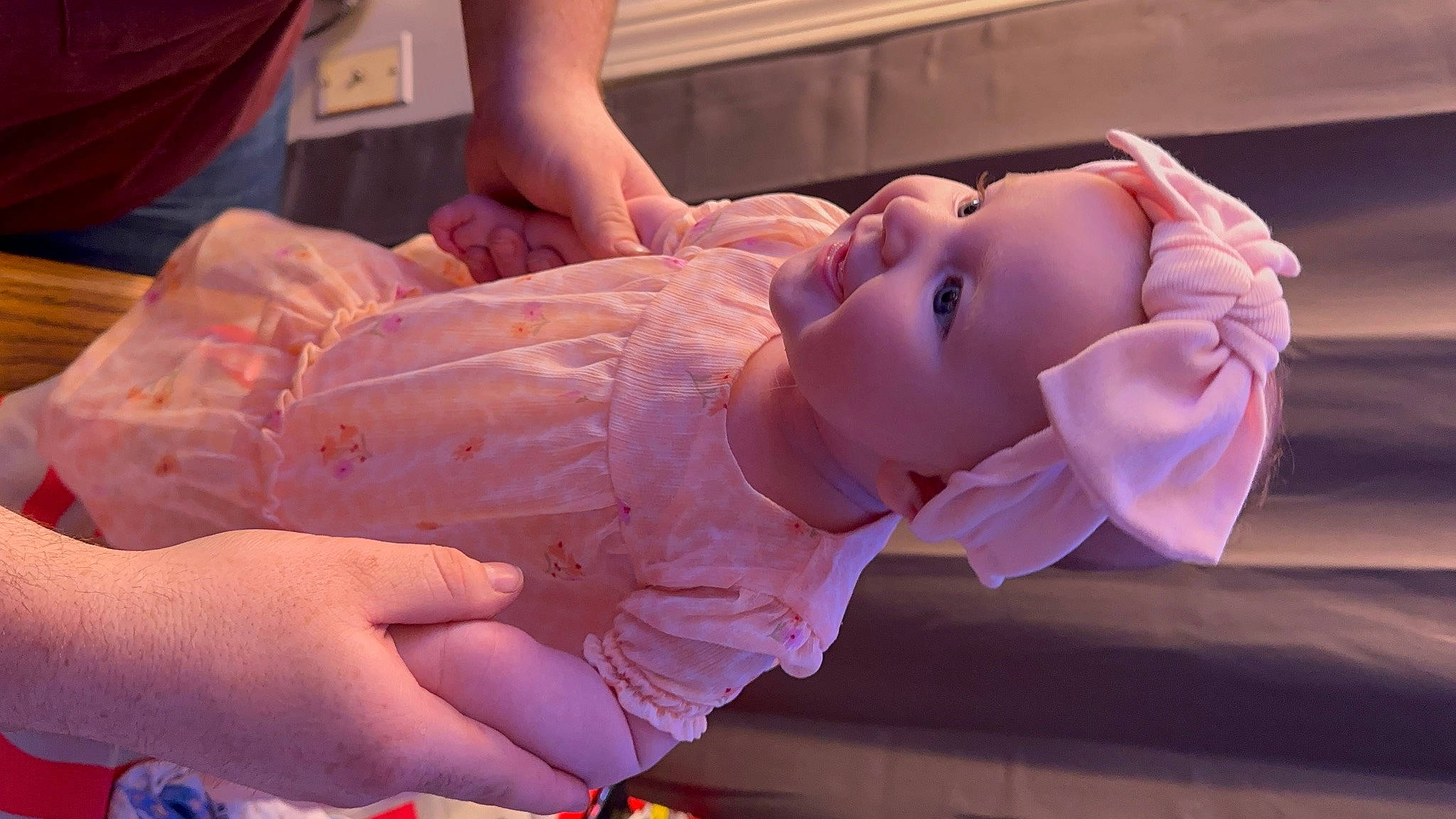 Esmé is registered to the contest to win money with this photo: arm, baby, baby_toddler_clothing, cheek, child, event, finger, fun, gesture, hand, mouth, muscle, nail, orange, person, pink, skin, thumb, toddler, water