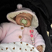 Layana participe au concours pour gagner de l'argent avec cette photo : baby, beads, blanket, button, child, clothing, cozy, cute, heart_pattern, hood, indoor, infant, knitwear, pacifier, peaceful, pink_jacket, portrait, sleeping, stroller, toy