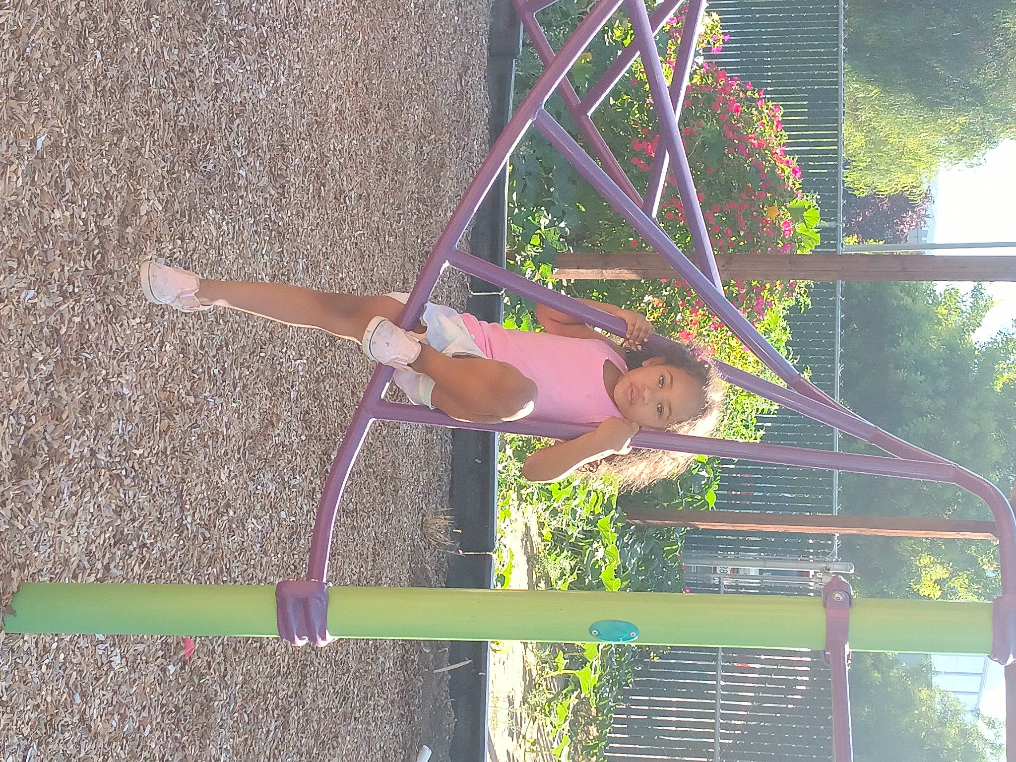 Promise is registered to the contest to win money with this photo: balance, city, elbow, fun, grass, leisure, magenta, outdoor_play_equipment, people_in_nature, person, playground, pole, recreation, shorts, smile, thigh, toddler, tree