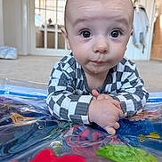 Oliver joined the competition — help win amazing prizes! baby, child, infant, striped_clothing, play_mat, colorful, curious, hands, lying_down, indoor, carpet, face, big_eyes, person, home, light, background, cute, portrait, tummy_time