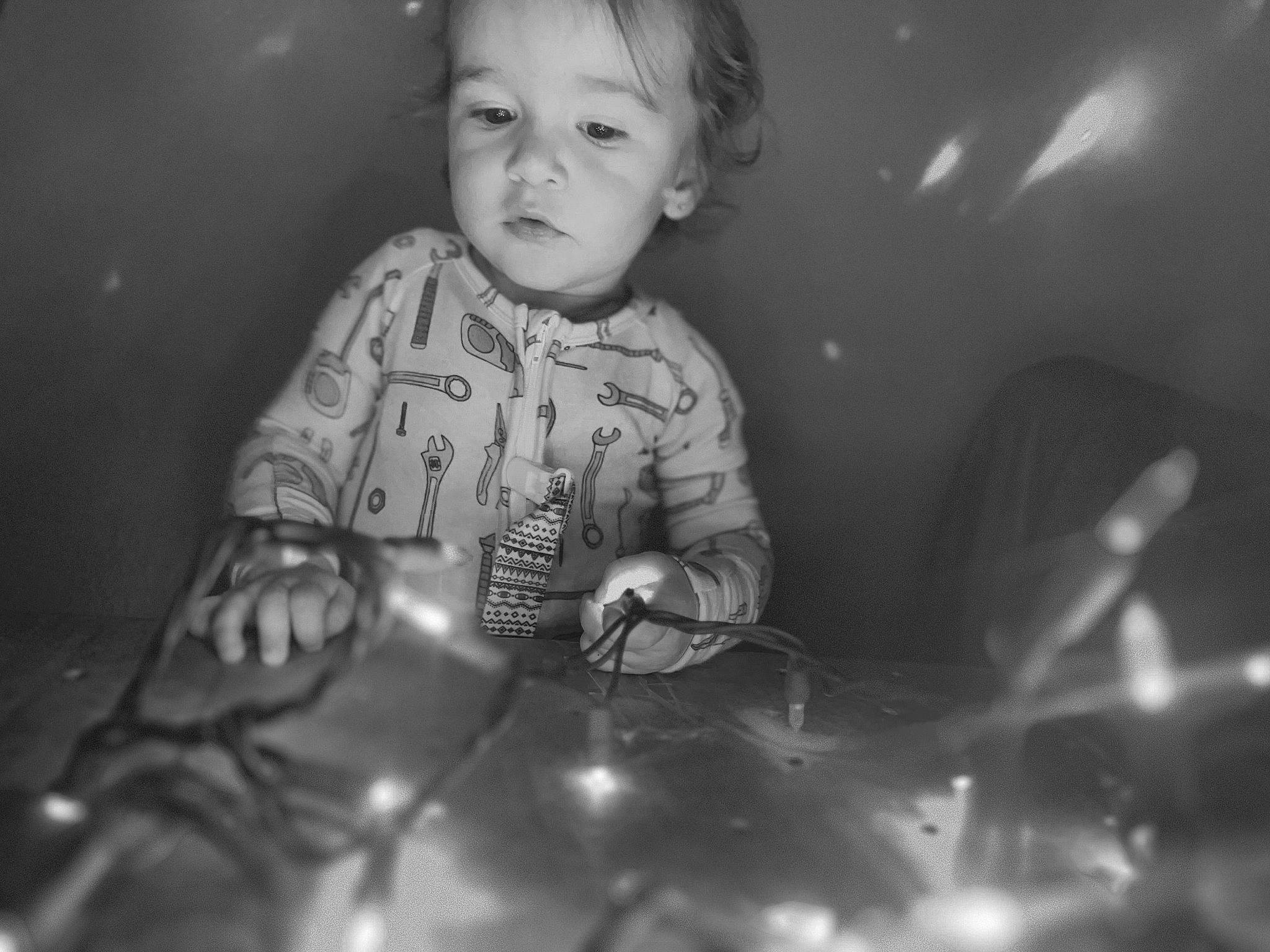 Emberly is registered to the contest to win money with this photo: automotive_lighting, black, black_and_white, cheek, child, darkness, eye, flash_photography, fun, happy, head, iris, monochrome, monochrome_photography, organ, person, sitting, still_life_photography, style, toddler