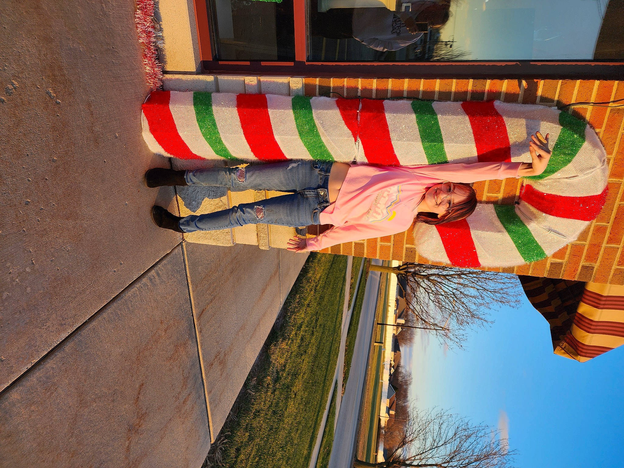 Maddison is registered to the contest to win money with this photo: building, facade, flag, flag_of_the_united_states, joy, leisure, light, line, pattern, person, plant, pole, red, shade, shadow, sky, tints_and_shades, tree, visual_arts, window