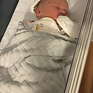 Gracie-Mai joined the competition — help win amazing prizes! newborn, baby, sleeping, blanket, crib, hat, bed, infant, cute, cozy, rest, soft, child, pajamas, mittens, indoors, peaceful, warm, person, sleep