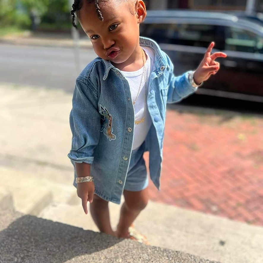 Jazayah is registered to the contest to win money with this photo: bodypart, child, city, clothing, coat, face, female, finger, girl, hand, head, jacket, jeans, pants, person, photography, portrait, road, shorts, street