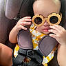 toddler, child, car_seat, sunglasses, yellow_dress, floral_pattern, seatbelt, cute, baby, portrait, indoors, child_safety, hands, face, fashion, summer, accessory, seat, straps, expression