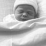newborn, baby, sleeping, blanket, hat, infant, cozy, soft, black_and_white, close_up, peaceful, face, wrapped, cute, child, bed, resting, portrait, indoors, quiet