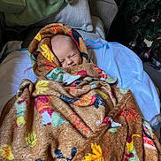 Raelynn joined the competition — help win amazing prizes! baby, blanket, smiling, cozy, indoor, child, face, pattern, colorful, autumn, leaf, wrapped, soft, couch, christmas_tree, holiday, cute, peaceful, portrait, infant