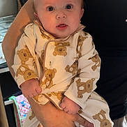 Cole joined the competition — help win amazing prizes! baby, infant, person, child, teddy_bear_pattern, clothing, cute, holding, hand, kitchen, flower, bouquet, utensils, adult, indoor, portrait, expression, face, skin, sleepsuit