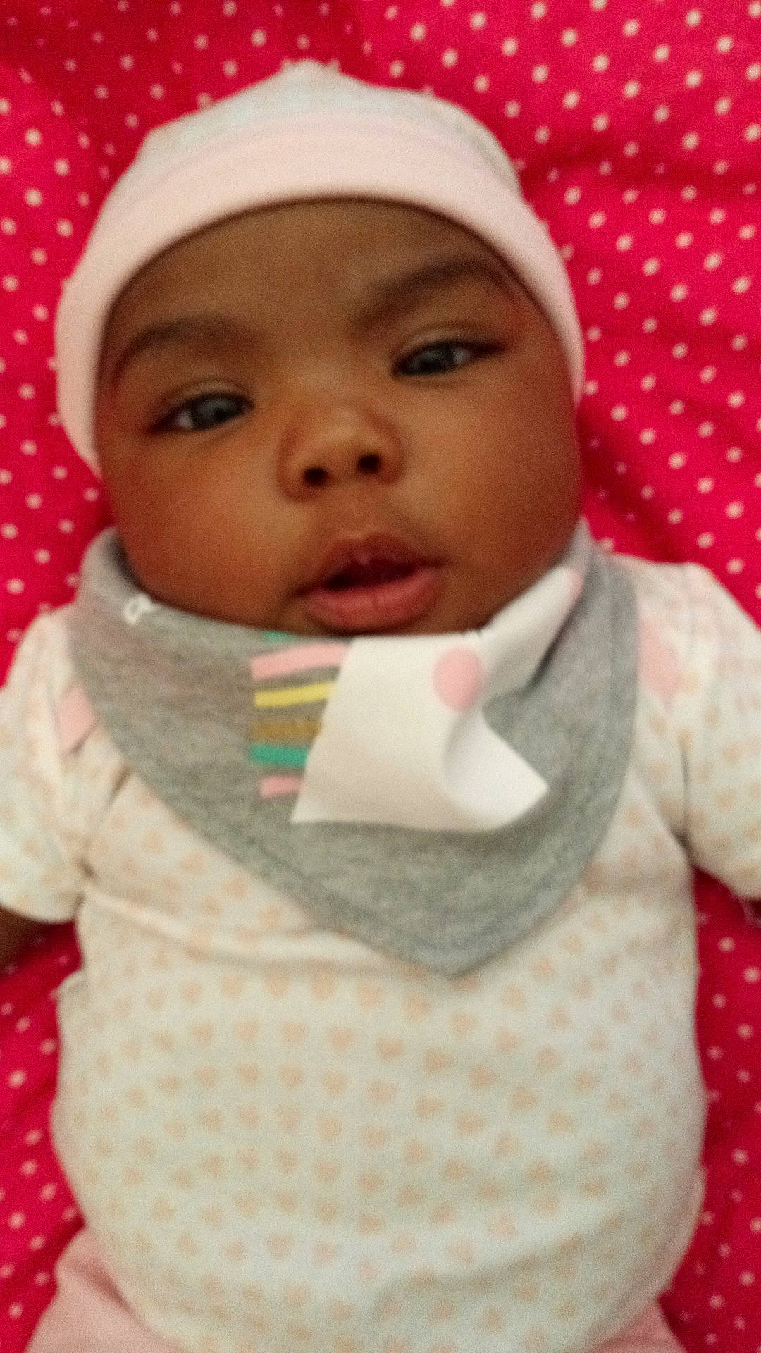 Queen is registered to the contest to win money with this photo: baby, baby_toddler_clothing, cap, cheek, chin, eye, eyebrow, face, happy, head, headwear, lip, mouth, nose, organ, outerwear, person, pink, skin, sleeve