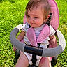 Nora joined the competition — help win amazing prizes! baby, casual, child, cute, daytime, grass, happy, infant, nature, outdoor, person, pink, playtime, seatbelt, sitting, stroller, summer, sunlight, toddler, young