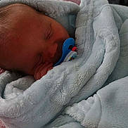 Waylon is registered to the contest to win money with this photo: baby, newborn, pacifier, blanket, sleeping, infant, soft, wrapped, cute, child, peaceful, cozy, indoors, portrait, head, face, hand, warm, comfort, rest