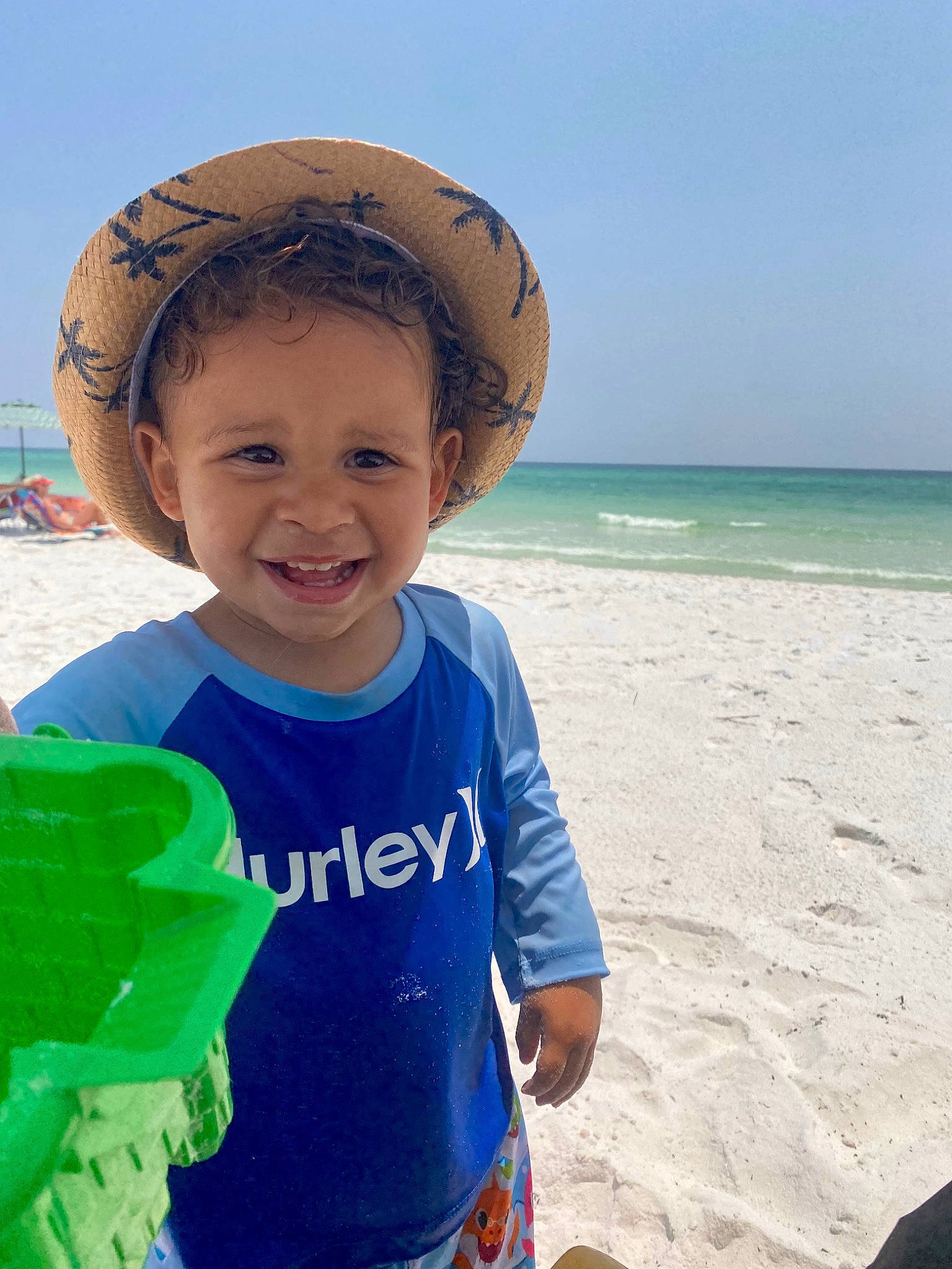 Rowen joined the competition — help win amazing prizes! azure, beach, cap, cool, happy, hat, joy, leisure, people_in_nature, people_on_beach, person, personal_protective_equipment, recreation, sky, sleeve, smile, summer, sun_hat, t_shirt, toddler