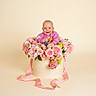 Berkley is registered to the contest to win money with this photo: baby, box, child, cute, decorative, floral, flower_arrangement, flowers, happy, infant, pastel_colors, person, pink, portrait, ribbon, roses, sitting, smile, soft_background, studio_shot