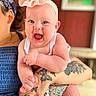 Berkley joined the competition — help win amazing prizes! adult, arm, baby, bandana, blue_dress, bow, child, cute, hand, happy, headband, holding, indoors, infant, laughing, person, portrait, skin, smiling, tattoo
