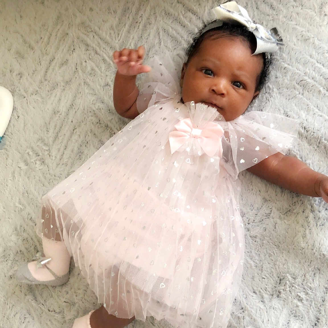 Xenia is registered to the contest to win money with this photo: baby, baby_toddler_clothing, child, costume, dress, fun, hair_accessory, person, product, skin, smile, toddler, white