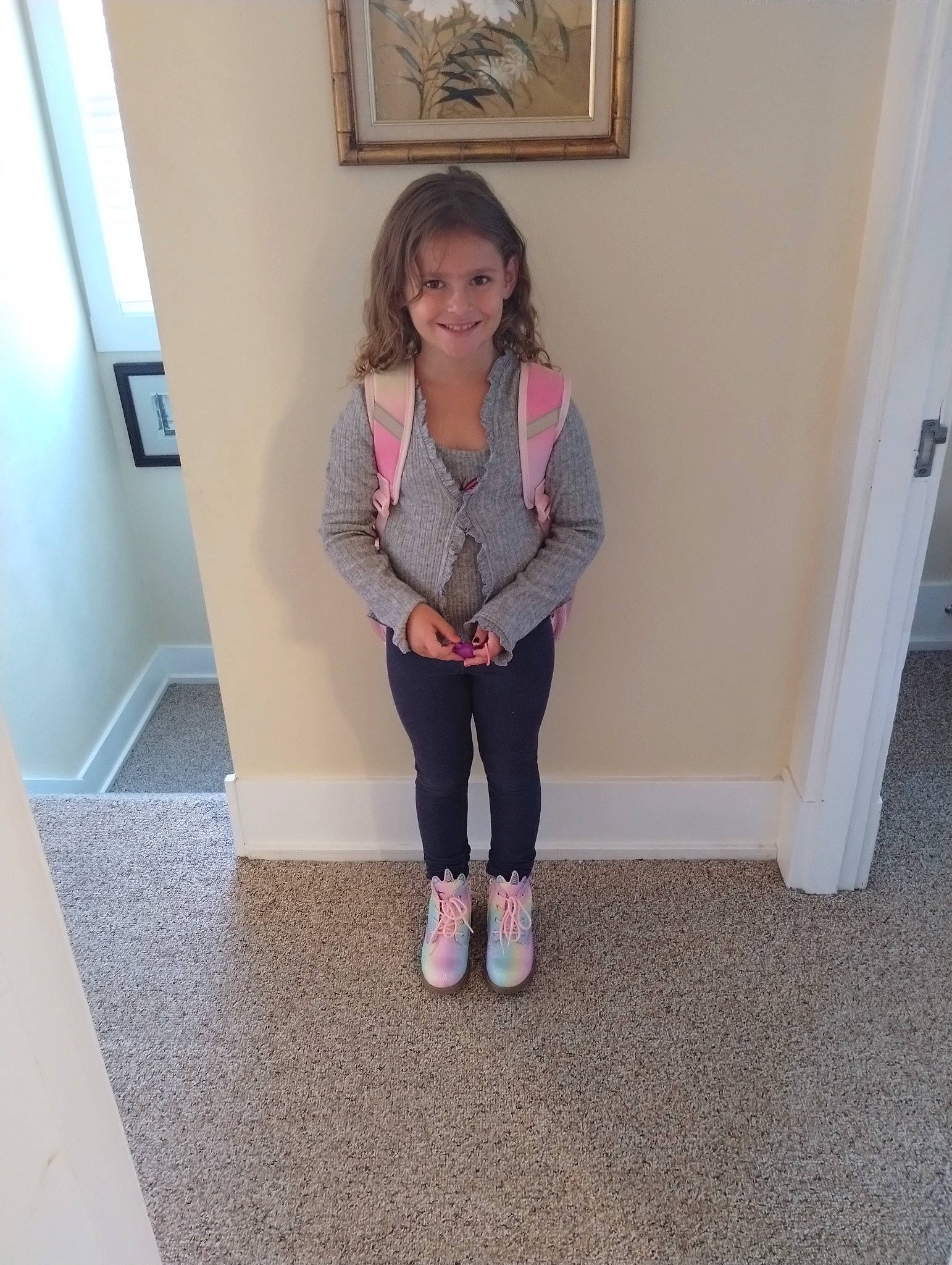 Bellissima is registered to the contest to win money with this photo: baby_toddler_clothing, door, floor, flooring, foot, hardwood, human_leg, joy, knee, magenta, pattern, person, picture_frame, sleeve, smile, sock, standing, textile, thigh, toddler