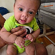Christian is registered to the contest to win money with this photo: architecture, baby, bodypart, building, clothing, couch, cushion, diaper, face, finger, furniture, hand, head, homedecor, indoors, person, photography, portrait, shorts, sitting