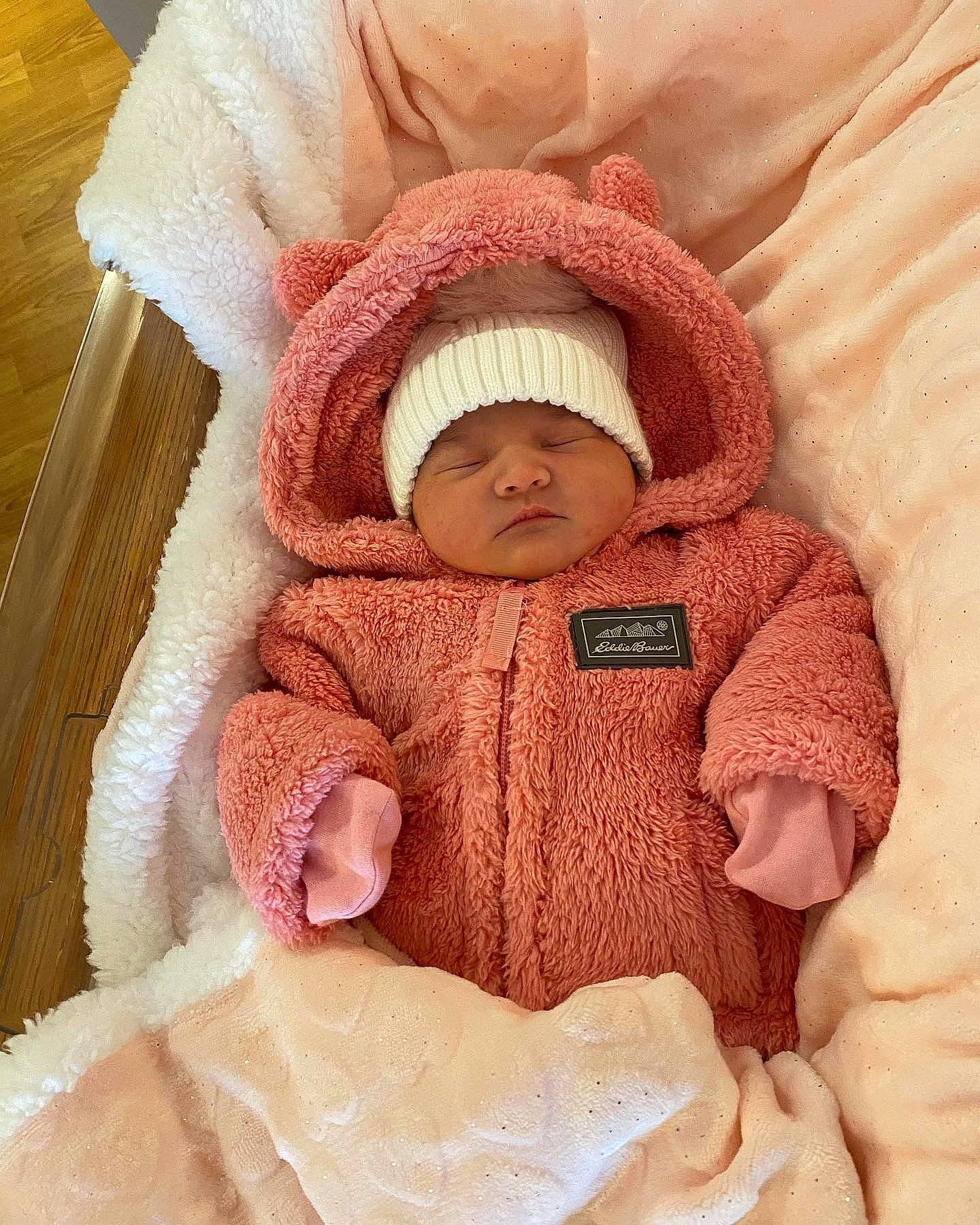 Juliette is registered to the contest to win money with this photo: baby, baby_sleeping, baby_toddler_clothing, beige, cheek, collar, comfort, eye, hand, head, headgear, headwear, human_body, jacket, linens, neck, person, pink, product, skin