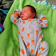 Aloni is registered to the contest to win money with this photo: baby, blanket, child, clothing, cozy, cute, cute_animal, green_blanket, indoors, infant, onesie, pattern, peaceful, plush_toy, rest, sleep, sleeping, soft_texture, tiger_print, toddler