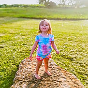 Beverly joined the competition — help win amazing prizes! barefoot, casual, child, colorful_clothing, daylight, field, grass, greenery, happy, nature, outdoor, portrait, rock, shorts, smiling, standing, summer, sunlight, tshirt, young_child