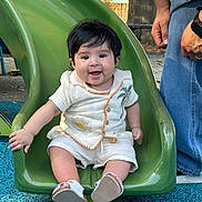 Luka joined the competition — help win amazing prizes! baby, child, slide, playground, green_slide, smiling, happy, outdoor, autumn, trees, person, jeans, hand, footwear, sun_embroidery, palm_tree_embroidery, casual_clothing, park, fall_leaves, fun