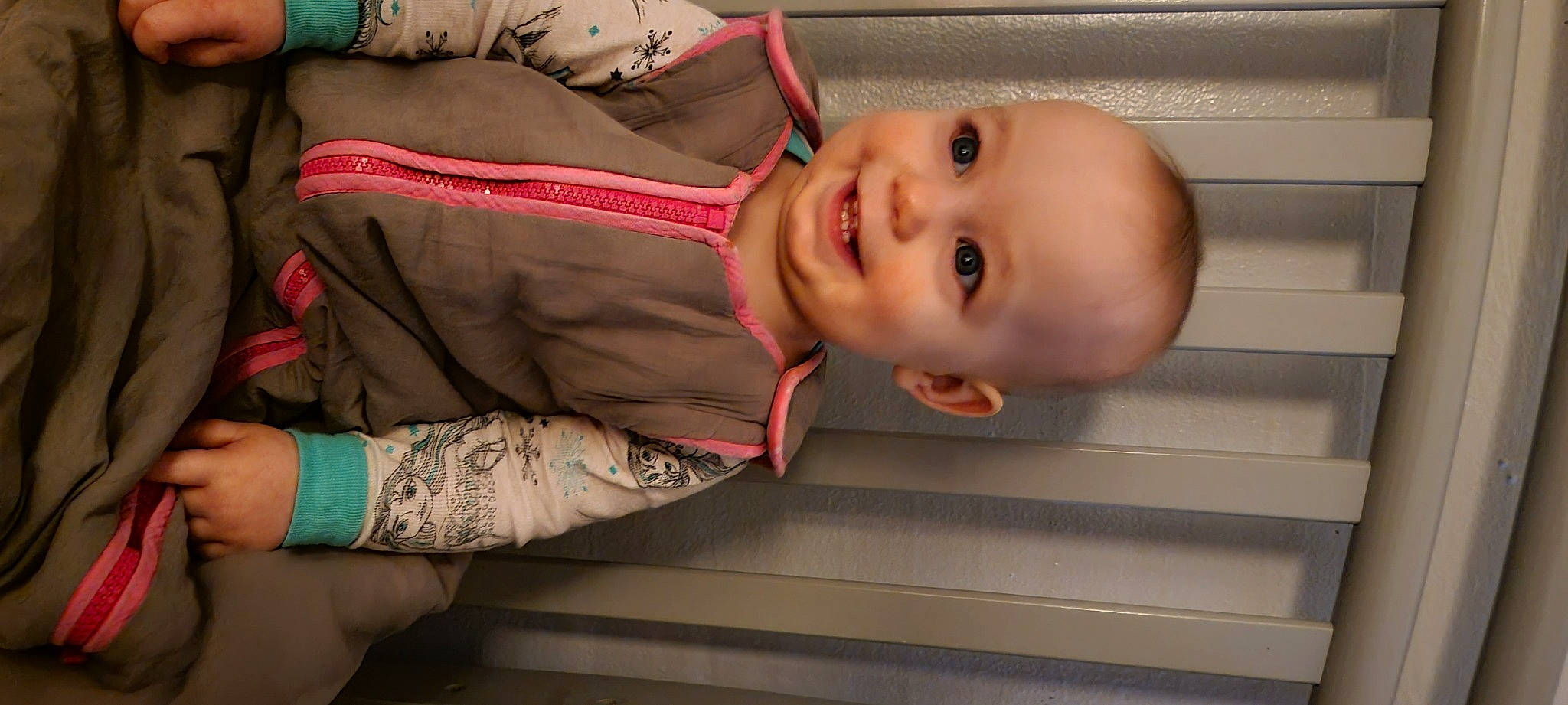 Ramona is registered to the contest to win money with this photo: baby, baby_laughing, baby_toddler_clothing, cheek, child, comfort, dress, elbow, finger, hand, happy, human_body, joy, lip, mouth, nose, person, skin, sleeve, smile