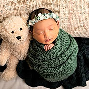 Taashvi joined the competition — help win amazing prizes! newborn, baby, sleeping, teddy_bear, knitted_blanket, floral_headband, pillow, cozy, cute, infant, soft_toy, wrapped, portrait, peaceful, child, indoors, resting, baby_sleep, adorable, comfort
