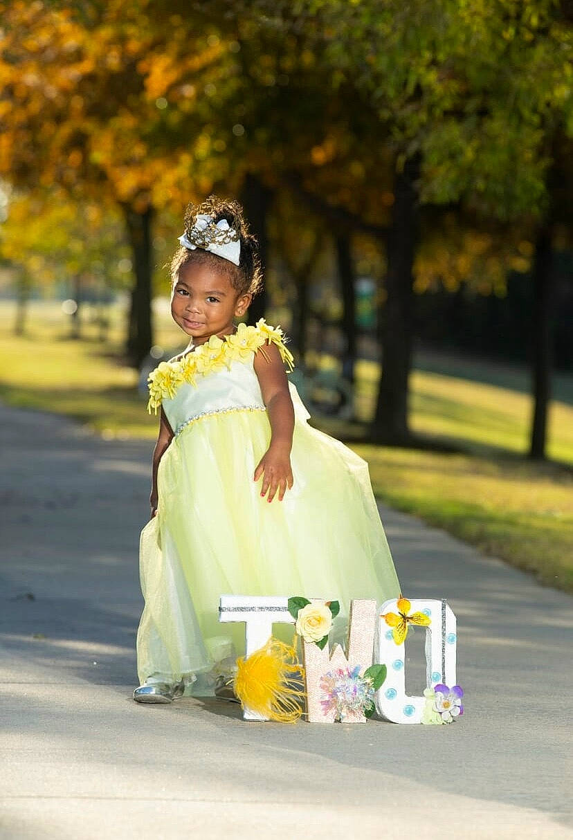 Denver joined the competition — help win amazing prizes! baby_toddler_clothing, bottle, bridal_clothing, child_model, day_dress, dress, embellishment, gown, hair_accessory, happy, headband, headpiece, joy, lavender, one_piece_garment, person, photo_shoot, portrait_photography, spring, tiara