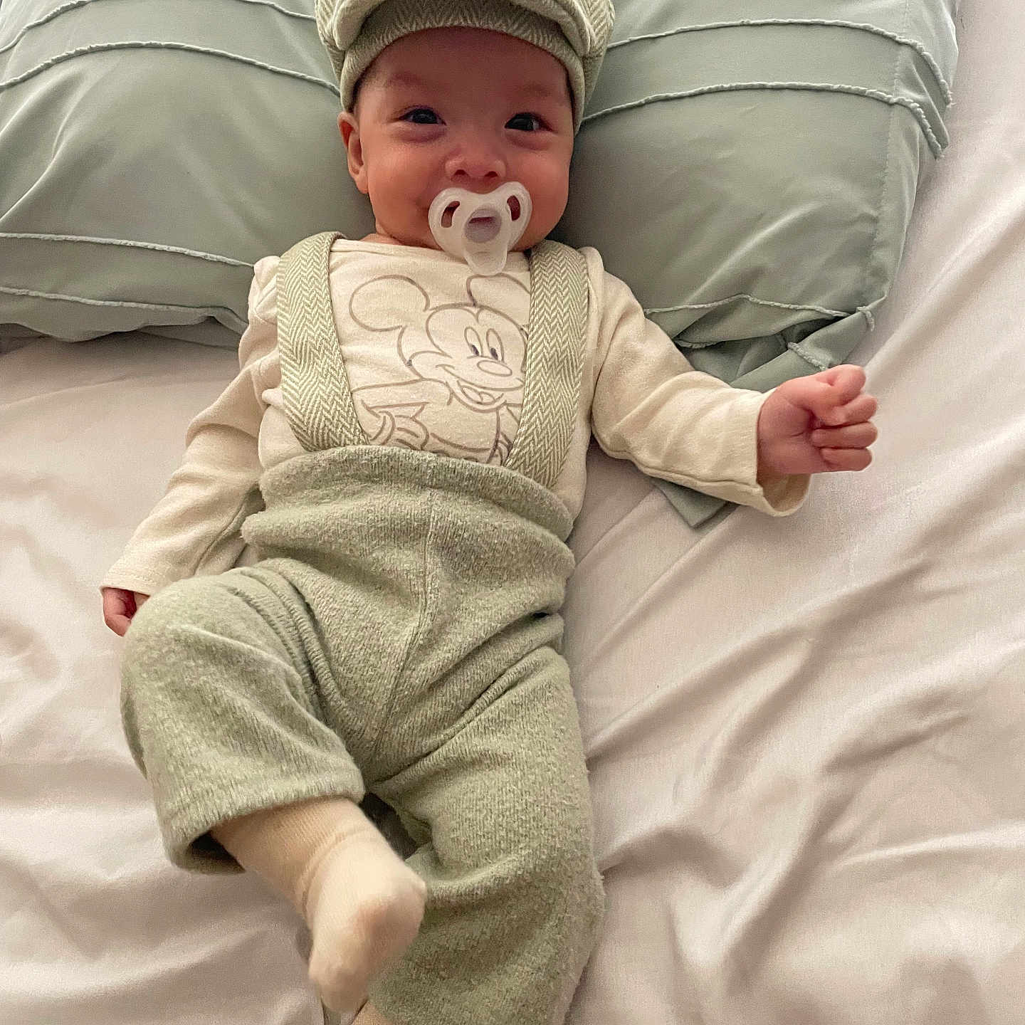 Luke is registered to the contest to win money with this photo: baby, bed, blanket, cap, clothing, cushion, face, furniture, happy, hat, head, homedecor, hosiery, pants, person, photography, pillow, portrait, smile, sock