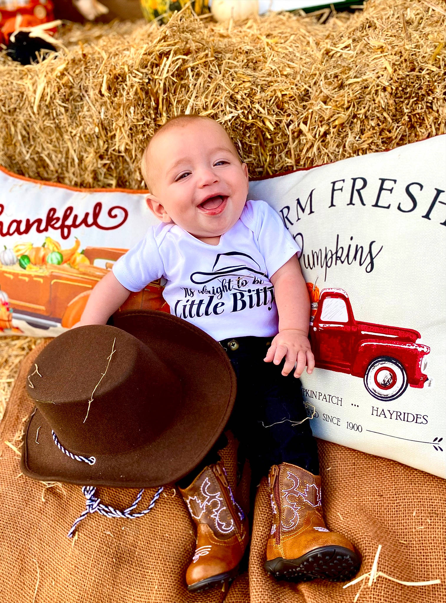Cylus is registered to the contest to win money with this photo: baby, baby_toddler_clothing, child, event, fun, grass, happy, hat, laugh, leisure, logo, people_in_nature, person, play, sitting, sleeve, smile, soil, sun_hat, t_shirt