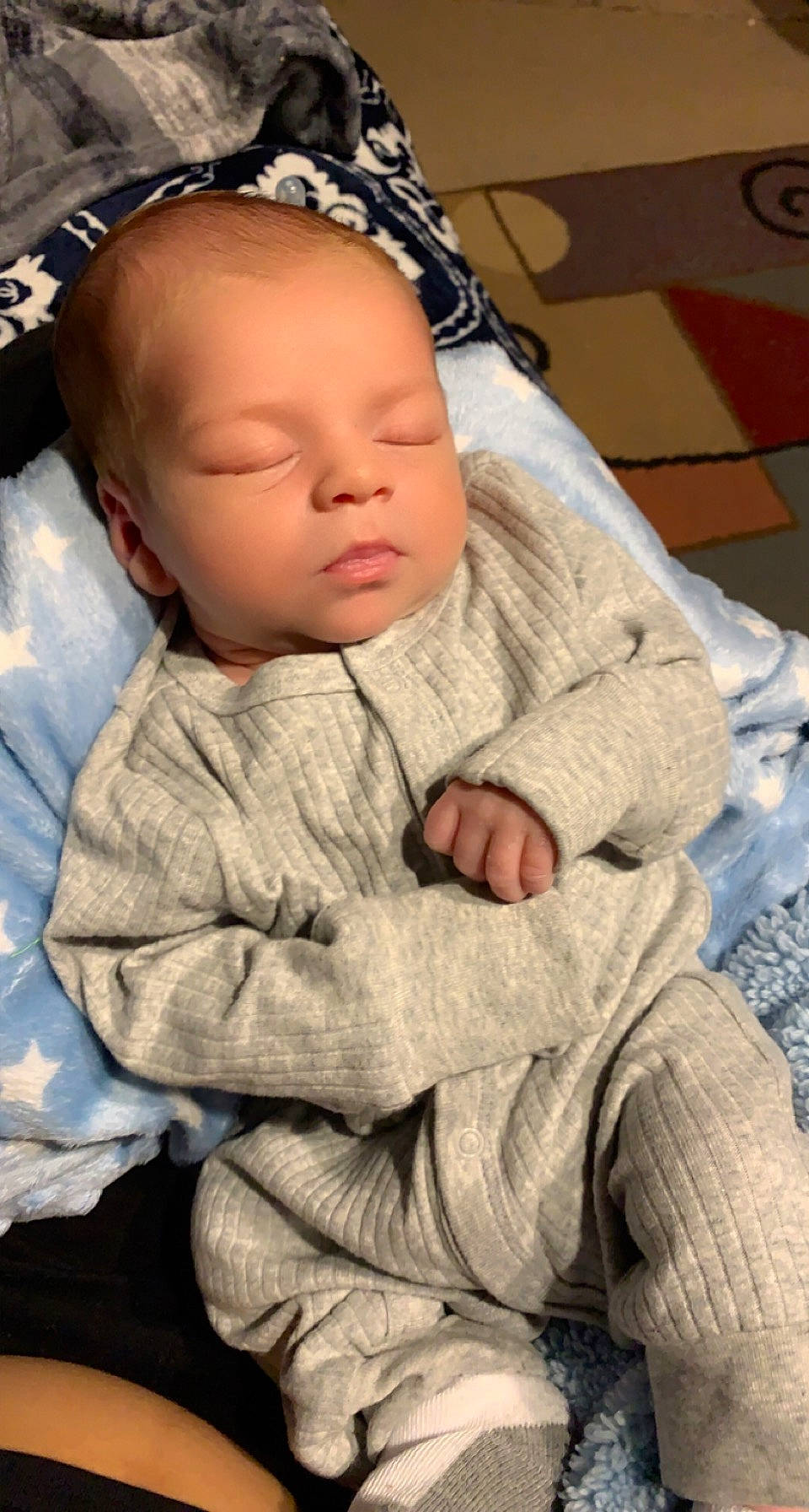 Cameron is registered to the contest to win money with this photo: baby, baby_sleeping, baby_toddler_clothing, cheek, chin, comfort, eye, face, finger, gesture, hand, head, human_body, lip, mouth, nose, person, skin, sleeve, thumb